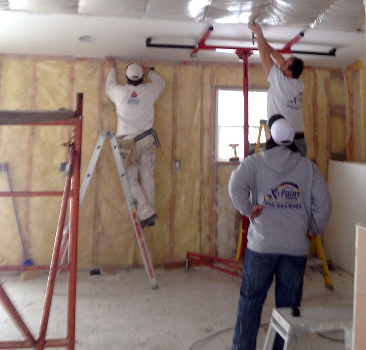 Rice's Paints Employees installing drywall